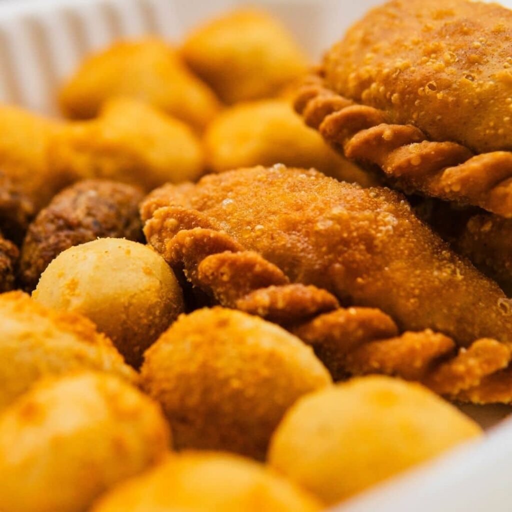 Assorted South American finger foods including cheese balls and croquettes.