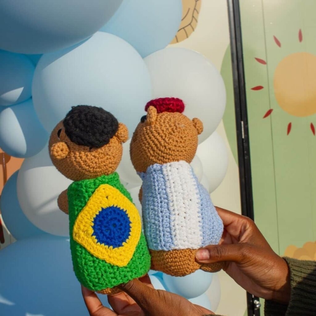 Crochet capybara mascots displayed on the food truck counter with a sign.