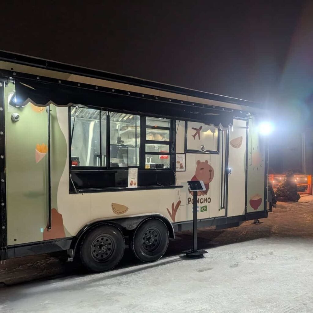 Nighttime view of Poncho food trailer set up for evening catering.