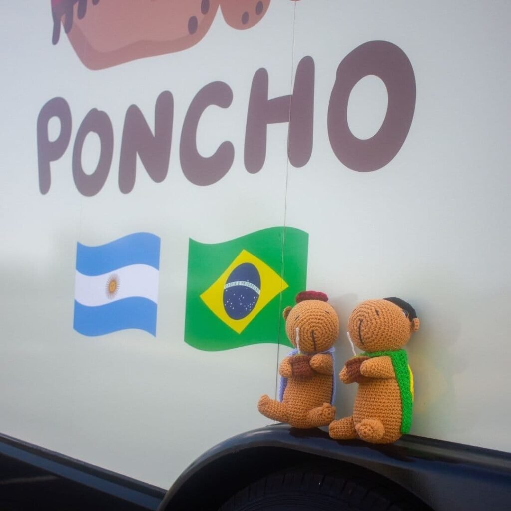 Poncho logo with Argentina and Brazil flags on the food truck wall.