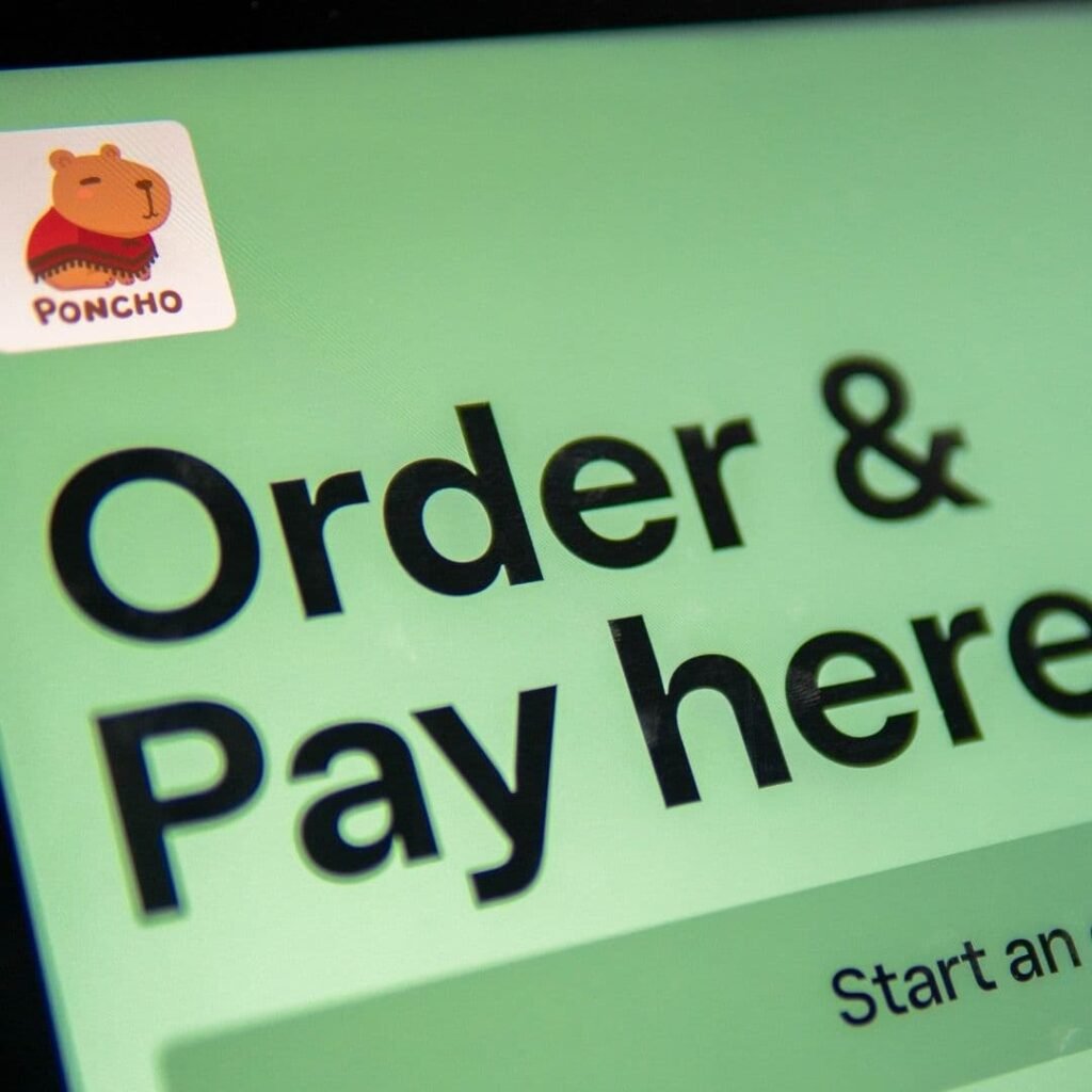 Digital order and pay screen at the Poncho food truck counter.